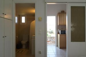 a bathroom with a toilet and a sink in a room at Studios Margarita in Artemonas