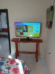a television sitting on a wooden table in a room at Private 1 Bedroom shared house in La Ceiba