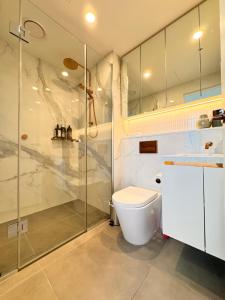 a bathroom with a toilet and a glass shower at Skyline Views Premium 2B2B Free Parking Box Hill in Box Hill