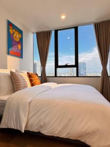 a bedroom with a large bed with a large window at Skyline Views Premium 2B2B Free Parking Box Hill in Box Hill