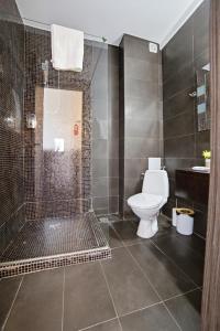 a bathroom with a shower and a toilet in it at InWaves in Vama Veche +11 photos