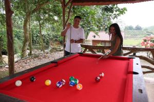 a man and a woman standing next to a pool table at LAS 7 CASCADAS Campground - Restaurant - Lodge in Cacaoal
