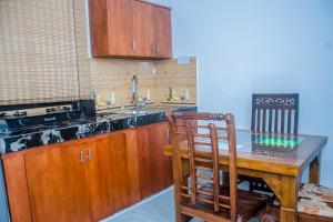a kitchen with a wooden table and a wooden chair at Breeze 12 Villa in Negombo