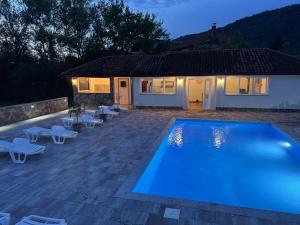 a swimming pool in front of a house at Althea Home & Wellness in Bihać