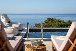 a pool with a view of the ocean from a resort at Villa Lefko in Ano Syros