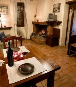 a living room with a table and a fireplace at Il Borghetto di Pedana- in Città di Castello