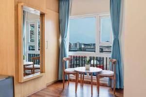 a room with a table and chairs and a window at Marlo Hotels in Kathmandu