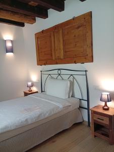 a bedroom with a bed with two tables and two lamps at Casa BORRIERO Farmhouse Charme B&B in Sospirolo