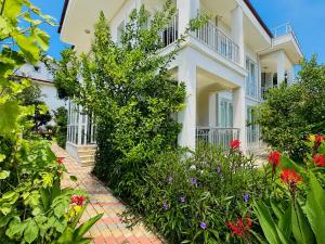 a house with flowers in front of it at Fethiye Merkezde Lüx Daire in Fethiye