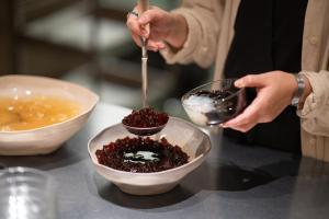 a person preparing food in a bowl on a counter at Oani in Taipei
