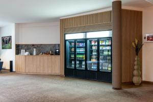 a refrigerator filled with lots of bottles of drinks at Best Western Plus iO Hotel in Eschborn