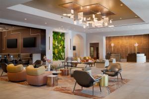 a lobby of a hotel with chairs and tables at Hilton Santa Clara - Newly Renovated in Santa Clara