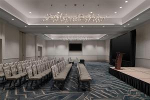 a conference room with chairs and a stage and a chandelier at Hilton Santa Clara - Newly Renovated in Santa Clara +50 photos