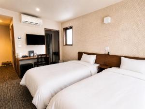 a hotel room with two beds and a desk at Floral Hotel Mari-Kyoto in Kyoto +29 photos