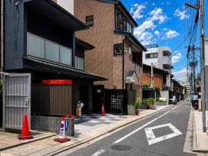 an empty street with orange cones in front of a building at Floral Hotel Mari-Kyoto in Kyoto