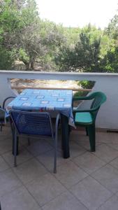 a picnic table and a bench on a patio at Apartments Irena in Božava