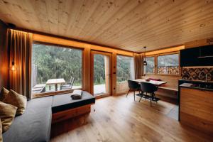 a room with a bed and a table with chairs at Chalet Tschogerhof Tiers am Rosengarten Dolomiten in Tires
