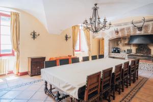 a large dining room with a table and a stove at Château de La Sizeranne - Beausemblant in Beausemblant