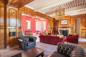 a living room with red furniture and a fireplace at Château de La Sizeranne - Beausemblant in Beausemblant