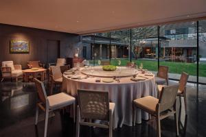 a dining room with a round table and chairs at Alila Shanghai in Shanghai