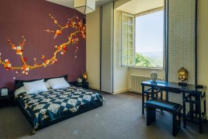 a bedroom with a bed and a desk and a tree mural at Château de La Sizeranne - Beausemblant in Beausemblant +24 photos