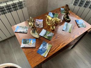 a wooden table with pictures on top of it at Tunduk House 14 in Bash-Kayyngdy