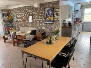 a kitchen and living room with a wooden table and chairs at CASA MARII Beachfront Villa in 2 Mai in 2 Mai