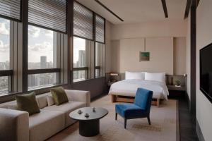 a hotel room with a bed and a couch at Alila Shanghai in Shanghai