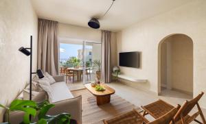 a living room with a couch and a table at WellClub Resort - Suites & Wellness in Paphos