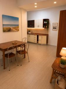 a dining room and kitchen with a table and chairs at BluTerra home in Porto San Giorgio +2 photos