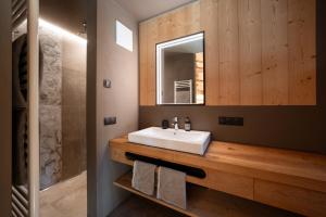 a bathroom with a white sink and a mirror at Chalet Tschogerhof Tiers am Rosengarten Dolomiten in Tires +127 photos