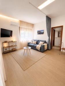 a living room with a couch and a table at BluTerra home in Porto San Giorgio