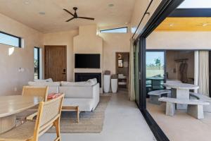 a living room with a couch and a table at Sand Tulum Retreat w Pool Spa in Yucca Valley