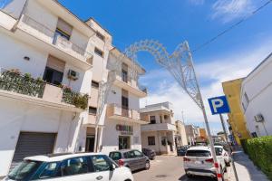 a street with cars parked in front of buildings at Al Calico in Galatone