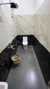 a black and white bathroom with a toilet and a sink at Gravity Groups Core - Sivadurai Residency in Puducherry Airpoert