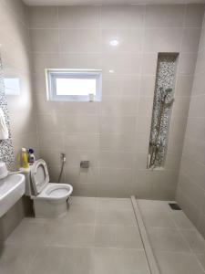 a white bathroom with a toilet and a sink at Penang Gelugor Landed House 4Rooms 3 Bathrooms in Gelugor +5 photos