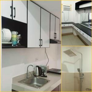 a kitchen with white cabinets and a sink at Cozy STUDIO for 4 Guests in Dasmariñas