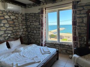 a bedroom with a bed and a large window at CASA MARII Beachfront Villa in 2 Mai in 2 Mai