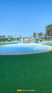 a large pool of water next to a beach at Jardines del Mar 1 in El Borseral