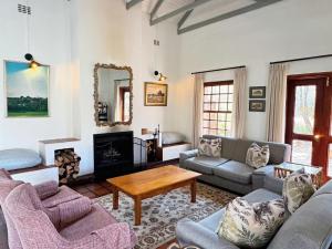 a living room with couches and a coffee table at Ntsinini Trout & Leisure Farm in Waterval Boven