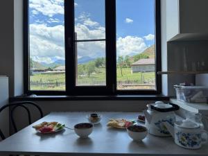 a table with plates of food and a window at Kolsai Terrassa in Saty