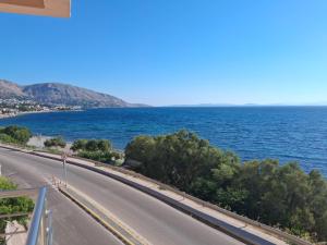 an empty road next to the ocean on a sunny day at Katrin chios in Chios