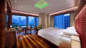 a hotel room with a bed and a table and chairs at Andaz Xintiandi, Shanghai, By Hyatt in Shanghai