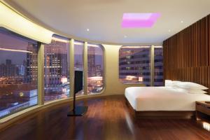 a bedroom with a large bed and large windows at Andaz Xintiandi, Shanghai, By Hyatt in Shanghai +36 photos