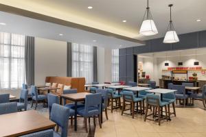 a dining room with tables and blue chairs at Hampton Inn & Suites - Roanoke-Downtown, VA in Roanoke