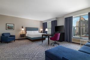 a hotel room with a bed and a desk at Hampton Inn & Suites - Roanoke-Downtown, VA in Roanoke