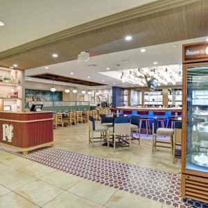 a restaurant with tables and chairs and a bar at DoubleTree by Hilton Nanuet in Nanuet