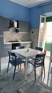 a kitchen with a white table and two chairs at Tower casa vacanze 2 in Anzio