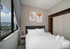 a bedroom with a white bed and a window at Iconic Regency Service Residences, managed by Iconic Hotel in Bayan Lepas