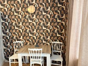 a dining room with a table and chairs with a wallpaper at Grand hotel dmanisi in Dmanisi